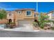 Two-story home featuring a two-car garage, low maintenance landscaping, and a neutral color scheme at 11120 Whooping Crane Ln, Las Vegas, NV 89144
