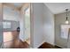 Bright hallway with hardwood floors leading to a bathroom and spacious living room at 11120 Whooping Crane Ln, Las Vegas, NV 89144