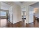 Upstairs hallway with dark wood flooring and multiple bedroom entrances at 11120 Whooping Crane Ln, Las Vegas, NV 89144