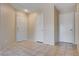 Hallway features neutral paint, tiled floor and multiple doors for privacy and functionality at 11120 Whooping Crane Ln, Las Vegas, NV 89144