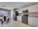 Updated kitchen boasts stainless appliances, white cabinetry, and adjacent dining area at 11120 Whooping Crane Ln, Las Vegas, NV 89144