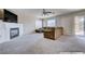 Spacious living room with fireplace, large sectional sofa, and sliding glass door at 11120 Whooping Crane Ln, Las Vegas, NV 89144