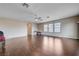 Expansive living room featuring hardwood floors, a ceiling fan and lots of natural light from large windows at 11120 Whooping Crane Ln, Las Vegas, NV 89144