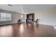 Spacious living room with hardwood floors, ceiling fan, built-in shelving and natural light from multiple windows at 11120 Whooping Crane Ln, Las Vegas, NV 89144