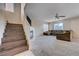 Open living area with a fireplace, comfortable sofa, and staircase access to the second floor at 11120 Whooping Crane Ln, Las Vegas, NV 89144