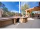 Outdoor kitchen featuring a built-in grill, countertop space, and a covered patio for entertaining guests at 11120 Whooping Crane Ln, Las Vegas, NV 89144