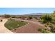 The backyard features an area of synthetic grass surrounded by landscaped rock at 1348 Basin Vw, Mesquite, NV 89034