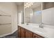 Bathroom boasts double sinks with a dark wood vanity, a large mirror and a separate tiled shower at 1348 Basin Vw, Mesquite, NV 89034