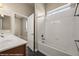 This bathroom includes a tiled shower and bathtub combo, dark wood vanity, and an open door to the bedroom at 1348 Basin Vw, Mesquite, NV 89034