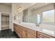 Bright bathroom featuring a double vanity with a long countertop and wooden cabinets at 1348 Basin Vw, Mesquite, NV 89034