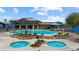 Community pool area with hot tubs, lush landscaping, and comfortable lounge seating, ideal for relaxation and social gatherings at 1348 Basin Vw, Mesquite, NV 89034