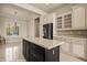 A kitchen featuring an island, glass cabinets, and modern appliances, creating a desirable cooking and gathering space at 1348 Basin Vw, Mesquite, NV 89034