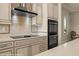 The kitchen featuring a stainless steel range hood, oven, and tile backsplash adds a touch of modern elegance at 1348 Basin Vw, Mesquite, NV 89034