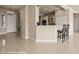 A bright, open kitchen with a breakfast bar and modern white cabinetry at 1348 Basin Vw, Mesquite, NV 89034