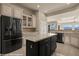 Bright kitchen with an island, stainless steel appliances, and view of mountains, adding to the charm and appeal at 1348 Basin Vw, Mesquite, NV 89034