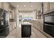 Spacious kitchen with modern appliances, an island, and neutral colors, all contributing to a welcoming atmosphere at 1348 Basin Vw, Mesquite, NV 89034