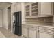 The modern kitchen features an island, glass cabinetry, and stainless-steel appliances, blending style with functionality at 1348 Basin Vw, Mesquite, NV 89034