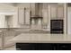 Modern kitchen featuring an island, stainless steel range hood and appliances, blending style and functionality at 1348 Basin Vw, Mesquite, NV 89034