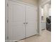 Laundry room with modern washer and dryer near tiled flooring and white cabinets at 1348 Basin Vw, Mesquite, NV 89034