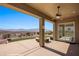 A covered outdoor patio with views of the landscaped backyard and mountain range in the distance at 1348 Basin Vw, Mesquite, NV 89034