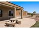 Exterior shot of the outdoor patio with stone table and benches at 1348 Basin Vw, Mesquite, NV 89034