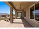 A covered patio with outdoor seating and views of the landscaped backyard at 1348 Basin Vw, Mesquite, NV 89034