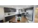 Modern kitchen featuring stainless steel appliances, dark cabinets, and stone backsplash at 1740 Capistrano Ave, Las Vegas, NV 89169