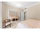 Bright bedroom with mirrored closet doors, and a view into an attached bathroom at 220 E Flamingo Rd # 111, Las Vegas, NV 89169