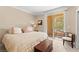 Cozy bedroom with neutral tones, balcony view, and mirrored closet doors at 220 E Flamingo Rd # 111, Las Vegas, NV 89169