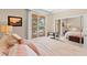 Bedroom with soft natural light, mirrored closet, view to balcony, and seating area at 220 E Flamingo Rd # 111, Las Vegas, NV 89169