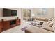 Cozy living room with a comfortable sectional, entertainment center, and natural light at 220 E Flamingo Rd # 111, Las Vegas, NV 89169