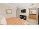 A bedroom features light-colored walls, a TV, and an attached bathroom with granite counters at 220 E Flamingo Rd # 111, Las Vegas, NV 89169