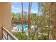 Beautiful swimming pool with palm trees and lounge chairs at a condo complex on a bright day at 220 E Flamingo Rd # 111, Las Vegas, NV 89169