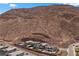 Aerial view of modern homes, showcasing pools, landscaping and proximity to the desert hillside at 298 Watteau Ct, Henderson, NV 89012