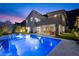 A modern home with a pool, landscaped backyard, and covered patio, ideal for entertaining and relaxation at 298 Watteau Ct, Henderson, NV 89012