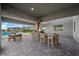 A backyard with a built-in bar and seating, pool view, and dining table for outdoor entertaining at 298 Watteau Ct, Henderson, NV 89012
