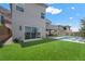 Expansive backyard with a pool, covered patio, and well-maintained lawn, perfect for outdoor living at 298 Watteau Ct, Henderson, NV 89012