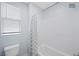 Bathroom features a shower-tub combination with white subway tile and a window for natural light at 298 Watteau Ct, Henderson, NV 89012
