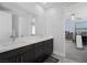 Modern bathroom with double sink vanity, sleek dark wood cabinets, and large mirror at 298 Watteau Ct, Henderson, NV 89012