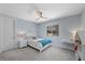 Comfortable bedroom with soft blue walls, a ceiling fan, and natural light at 298 Watteau Ct, Henderson, NV 89012