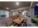 A spacious covered patio features a wooden dining set, a built-in bar, and access to the home's interior at 298 Watteau Ct, Henderson, NV 89012