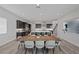 Dining room with modern chairs and large wood table adjacent to the kitchen, great for Gathering meals at 298 Watteau Ct, Henderson, NV 89012