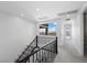 Upstairs hallway features gray carpet, modern railings, and transom window for natural light at 298 Watteau Ct, Henderson, NV 89012
