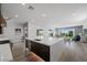 Modern kitchen with a large island, stainless steel appliances, dark cabinets, and an open floor plan at 298 Watteau Ct, Henderson, NV 89012