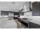 Well-equipped kitchen with stainless steel appliances, quartz countertops, and a large island for meal preparation at 298 Watteau Ct, Henderson, NV 89012