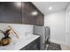Contemporary laundry room features gray cabinetry, white countertops, and modern washer and dryer at 298 Watteau Ct, Henderson, NV 89012