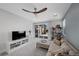 Cozy living room with plush seating, ceiling fan, and access to the outdoor patio at 298 Watteau Ct, Henderson, NV 89012