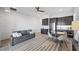 Bright living room with a modern sofa, dining area, stylish rug, and ceiling fan at 298 Watteau Ct, Henderson, NV 89012