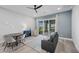Spacious living room with a modern sofa, dining table, and sliding glass doors to the backyard at 298 Watteau Ct, Henderson, NV 89012