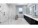 Modern main bathroom with a walk-in shower, double vanity, and contemporary fixtures at 298 Watteau Ct, Henderson, NV 89012